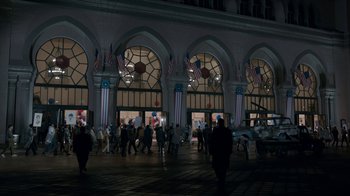 Movie still from “All the Way” (2016), directed by Jay Roach – A group of people walking in front of a building; Extreme Wide shot, High angle