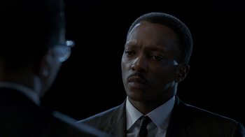 Movie still from “All the Way” (2016), directed by Jay Roach – A man wearing a suit and tie looking at a mirror; Close Up shot, Over the shoulder angle