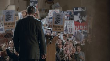 Movie still from “All the Way” (2016), directed by Jay Roach – A man is giving a speech to a crowd of people; Medium shot, High angle