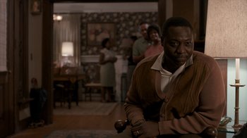 Movie still from “All the Way” (2016), directed by Jay Roach – An older man holding a cane in a living room; Medium shot, High angle