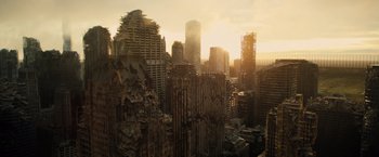 Movie still from “Allegiant” (2016), directed by Robert Schwentke – A view of a city skyline at sunset with the sun setting; Extreme Wide shot, High angle