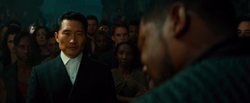 Movie still from “Allegiant” (2016), directed by Robert Schwentke – A group of people standing in a dark room; Close Up shot, Over the shoulder angle