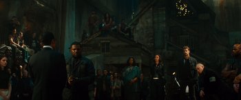 Movie still from “Allegiant” (2016), directed by Robert Schwentke – A group of people standing in front of a building; Wide shot, High angle