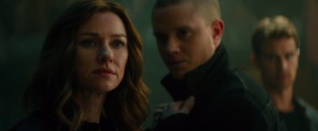 Movie still from “Allegiant” (2016), directed by Robert Schwentke – A man and a woman standing next to each other; Close Up shot, Over the shoulder angle