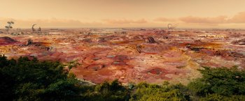 Movie still from “Allegiant” (2016), directed by Robert Schwentke – An aerial view of a desert landscape at sunset; Extreme Wide shot, High angle