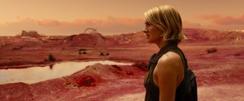 Movie still from “Allegiant” (2016), directed by Robert Schwentke – A woman standing in front of a desert landscape; Medium shot, Over the shoulder angle