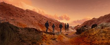 Movie still from “Allegiant” (2016), directed by Robert Schwentke – A group of people standing on top of a hill; Extreme Wide shot, High angle