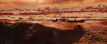Movie still from “Allegiant” (2016), directed by Robert Schwentke – A view of a sandy beach with a cloudy sky in the background; Extreme Wide shot, High angle