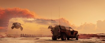 Movie still from “Allegiant” (2016), directed by Robert Schwentke – An armored vehicle driving down a dirt road at sunset; Extreme Wide shot, Low angle