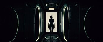 Movie still from “Allegiant” (2016), directed by Robert Schwentke – A woman is standing in a room with lights on; Wide shot, Low angle