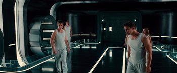 Movie still from “Allegiant” (2016), directed by Robert Schwentke – A group of young men standing in a dark room; Wide shot, Low angle