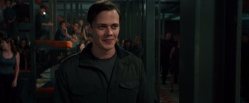 Movie still from “Allegiant” (2016), directed by Robert Schwentke – A man standing in front of a group of people; Close Up shot, Over the shoulder angle