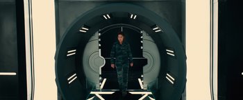 Movie still from “Allegiant” (2016), directed by Robert Schwentke – A woman standing inside of a room with lights on; Wide shot, Overhead angle