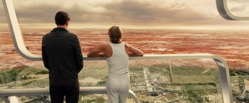 Movie still from “Allegiant” (2016), directed by Robert Schwentke – A woman standing on a balcony looking out over a city; Wide shot, High angle