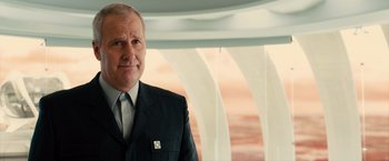 Movie still from “Allegiant” (2016), directed by Robert Schwentke – A person wearing a suit and tie; Close Up shot, Over the shoulder angle