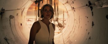 Movie still from “Allegiant” (2016), directed by Robert Schwentke – A woman standing in front of a wall; Medium shot, Low angle