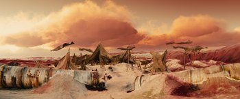 Movie still from “Allegiant” (2016), directed by Robert Schwentke – An artistic rendering of a desert scene with tents; Extreme Wide shot, High angle