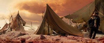 Movie still from “Allegiant” (2016), directed by Robert Schwentke – An old sail boat on the beach under a cloudy sky; Extreme Wide shot, Low angle