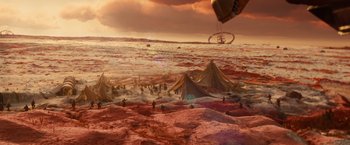 Movie still from “Allegiant” (2016), directed by Robert Schwentke – A group of people standing on top of a sandy beach; Extreme Wide shot, High angle