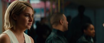 Movie still from “Allegiant” (2016), directed by Robert Schwentke – A woman standing next to a man in a crowd; Close Up shot, Over the shoulder angle