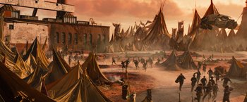 Movie still from “Allegiant” (2016), directed by Robert Schwentke – A group of people standing in a field with tents on top; Extreme Wide shot, High angle