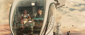 Movie still from “Allegiant” (2016), directed by Robert Schwentke – A man and a woman are inside of a train; Wide shot, High angle