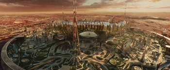 Movie still from “Allegiant” (2016), directed by Robert Schwentke – An aerial view of a futuristic city with many buildings; Extreme Wide shot, High angle