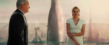 Movie still from “Allegiant” (2016), directed by Robert Schwentke – A woman in a white dress standing in front of a fountain; Medium shot, Low angle