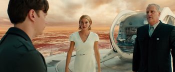 Movie still from “Allegiant” (2016), directed by Robert Schwentke – A woman in a white dress standing in front of a helicopter; Medium shot, Low angle