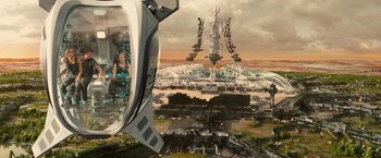 Movie still from “Allegiant” (2016), directed by Robert Schwentke – An aerial view of a city with a tower and buildings; Extreme Wide shot, Overhead angle