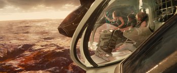 Movie still from “Allegiant” (2016), directed by Robert Schwentke – A woman is standing in the window of an airplane; Wide shot, High angle