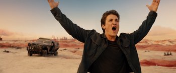 Movie still from “Allegiant” (2016), directed by Robert Schwentke – A man with his mouth wide open and his arms outstretched; Medium shot, Low angle