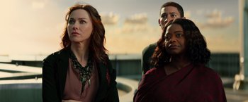 Movie still from “Allegiant” (2016), directed by Robert Schwentke – A group of people standing next to each other on a bridge; Medium shot, Over the shoulder angle