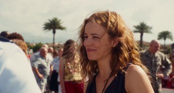 Movie still from “Aloha” (2015), directed by Cameron Crowe – A person with curly hair; Close Up shot, Over the shoulder angle