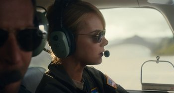 Movie still from “Aloha” (2015), directed by Cameron Crowe – A woman in a helicopter with a headset on; Close Up shot, Low angle