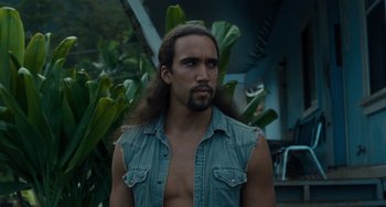 Movie still from “Aloha” (2015), directed by Cameron Crowe – A man with long hair is standing outside; Close Up shot, Low angle