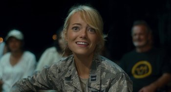 Movie still from “Aloha” (2015), directed by Cameron Crowe – A person wearing a uniform smiling; Close Up shot, Over the shoulder angle