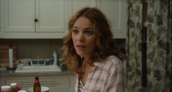 Movie still from “Aloha” (2015), directed by Cameron Crowe – A woman in a plaid shirt is looking at the camera; Close Up shot, Over the shoulder angle