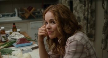 Movie still from “Aloha” (2015), directed by Cameron Crowe – A beautiful young lady sitting at a kitchen counter; Close Up shot, Over the shoulder angle
