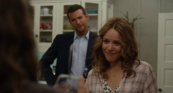 Movie still from “Aloha” (2015), directed by Cameron Crowe – A man and a woman are standing in front of a mirror; Close Up shot, Over the shoulder angle
