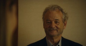 Movie still from “Aloha” (2015), directed by Cameron Crowe – A man in a black jacket and a white shirt; Close Up shot, Low angle