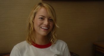 Movie still from “Aloha” (2015), directed by Cameron Crowe – A woman with blonde hair wearing a red and white t - shirt; Close Up shot, Over the shoulder angle