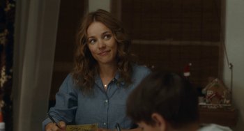 Movie still from “Aloha” (2015), directed by Cameron Crowe – A woman sitting at a table with a boy; Close Up shot, Over the shoulder angle