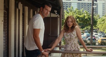 Movie still from “Aloha” (2015), directed by Cameron Crowe – A man and a woman standing next to a railing; Medium shot, Low angle