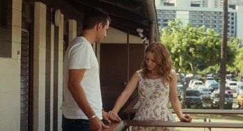 Movie still from “Aloha” (2015), directed by Cameron Crowe – A man and a woman standing next to a railing; Medium shot, Over the shoulder angle