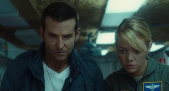 Movie still from “Aloha” (2015), directed by Cameron Crowe – A man and a woman standing next to each other; Close Up shot, Low angle