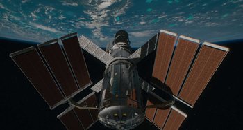 Movie still from “Aloha” (2015), directed by Cameron Crowe – A view of a space station taken from below it; Extreme Wide shot, Overhead angle