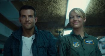 Movie still from “Aloha” (2015), directed by Cameron Crowe – A man and a woman standing next to each other; Close Up shot, Over the shoulder angle