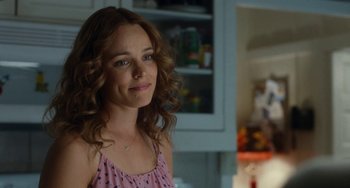 Movie still from “Aloha” (2015), directed by Cameron Crowe – A person with curly hair in a room; Close Up shot, Over the shoulder angle