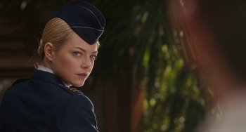 Movie still from “Aloha” (2015), directed by Cameron Crowe – A woman in a uniform is looking at the camera; Close Up shot, Over the shoulder angle